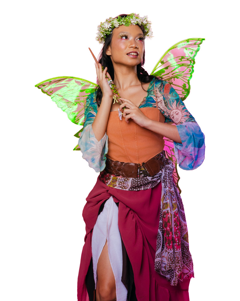 A fairy costume with a flower crown, green wings and colorful layered scarves.